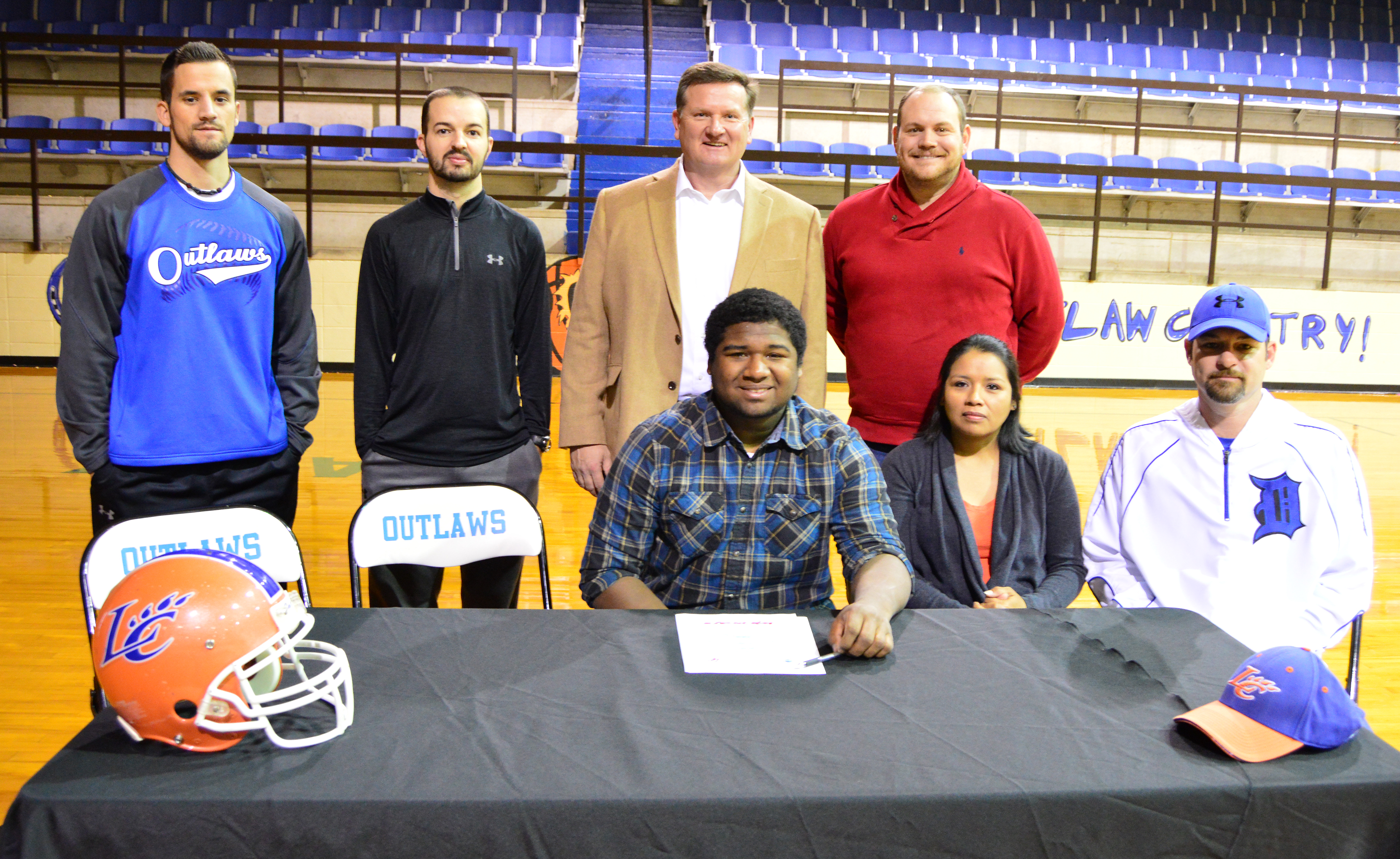 FUTURE WILDCAT. Dierks High School Outlaw tailback Trendin McKinney signed a letter of intent to play football with the Louisiana College Wildcats during a ceremony Friday morning. McKinney is pictured with his parents Kara and Matt Hill and coaches Dustin Bissell, Kevin Alexander, David Bennett and Stephen Sprick. Not pictured is coach Jeff Tipton.