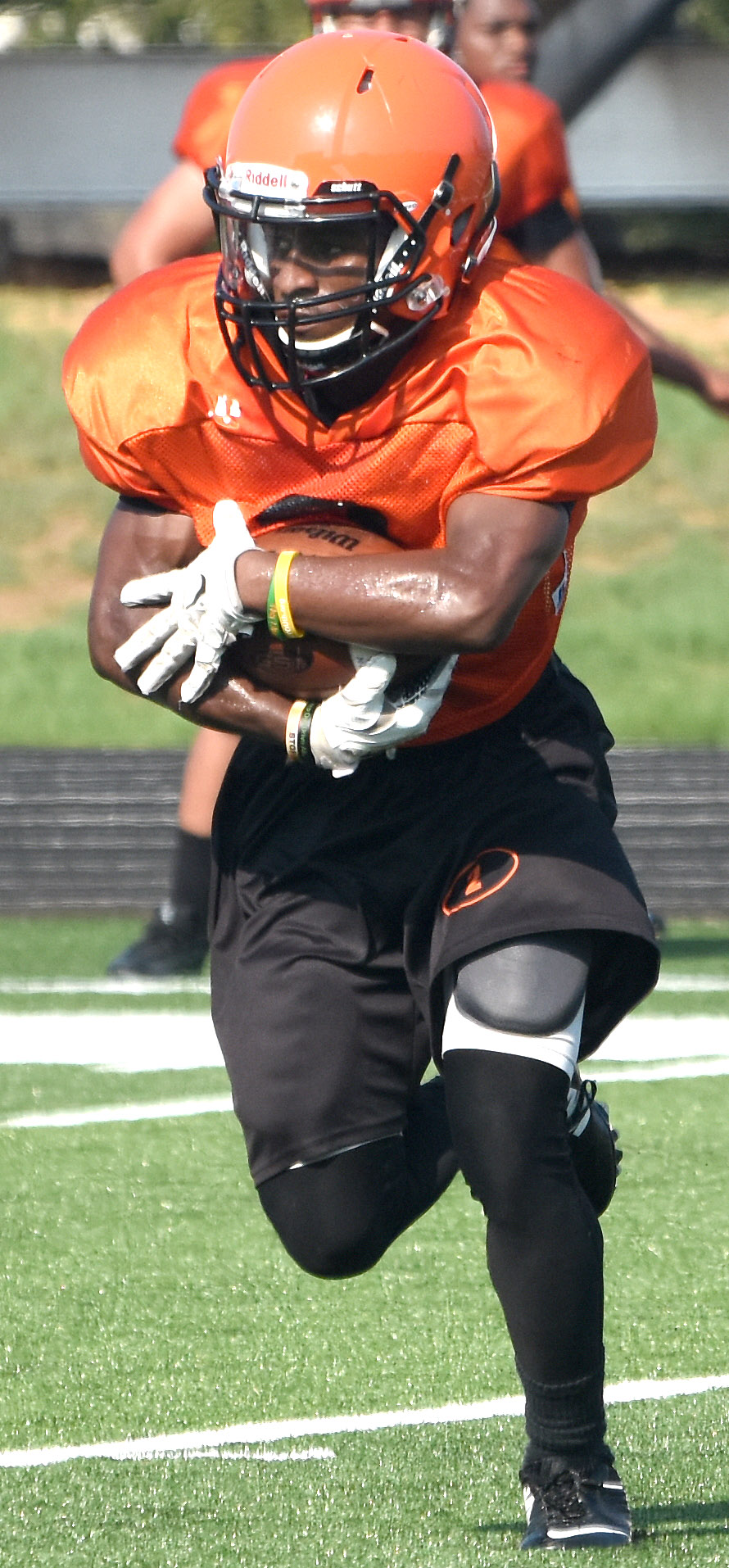 Jhalon Finley secures the ball as he gains ground during the scrimmage.
