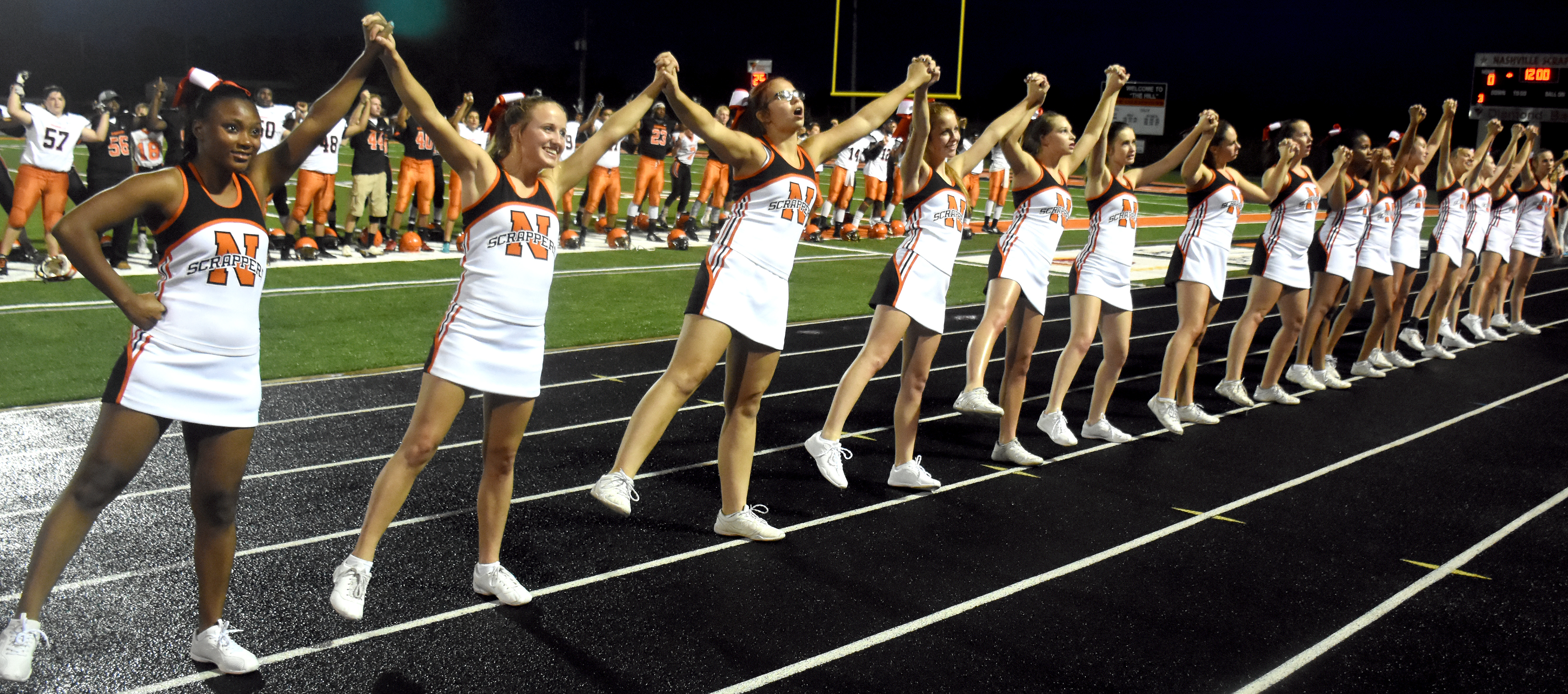 The Scrapper Cheerleaders sing the NHS Alma Mater Friday night at the Back-to-School Bash.