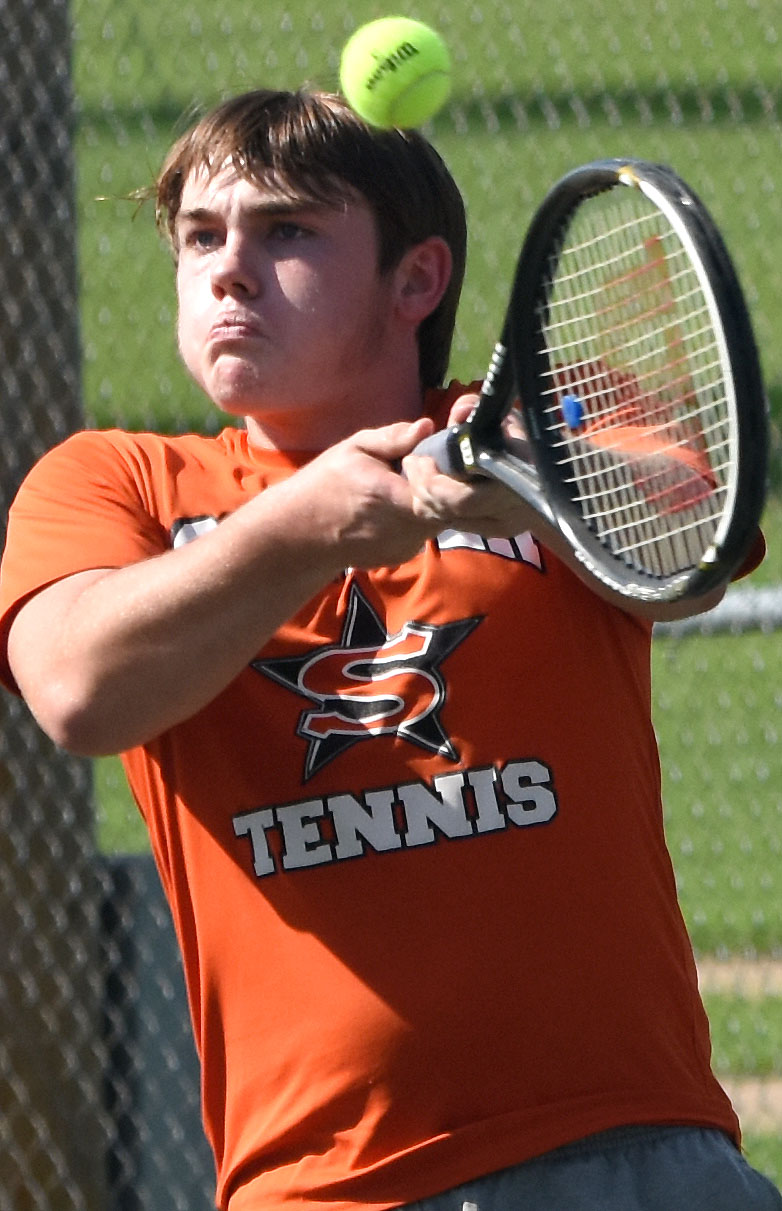 Zack Backus (above) and Glenn Hartness (below) play in doubles wins over Malvern.