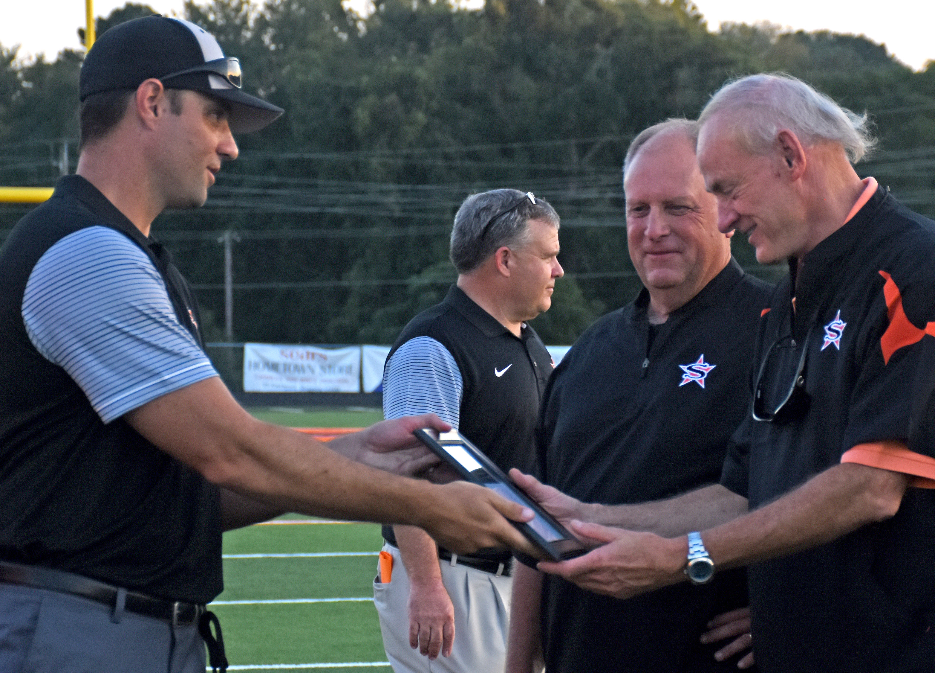 Coach Mike Volarvich presents a picture of Scrapper Stadium to thurf donor Dr. Tim Bainum of Diamond Bank as Bob Jamison watches before Friday's game. All of the turf sponsors were recognized in a pre-game ceremony.