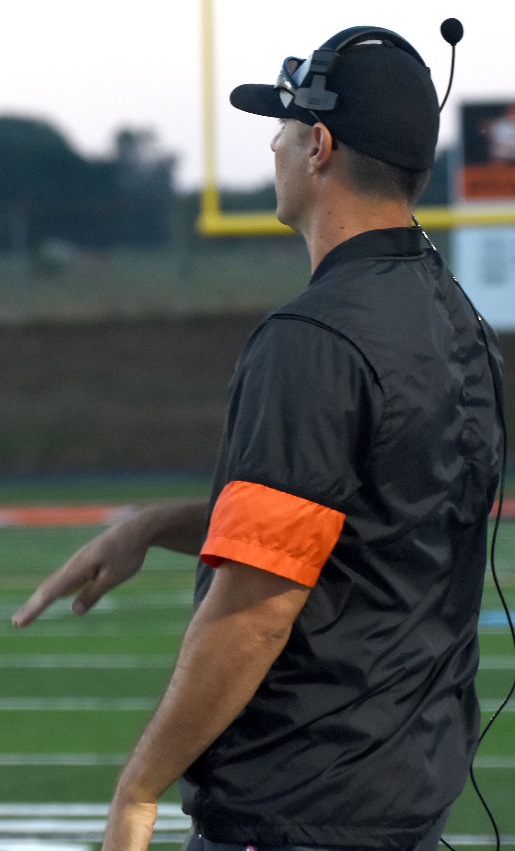 Coach Mike Volarvich signals the play from the sideline.