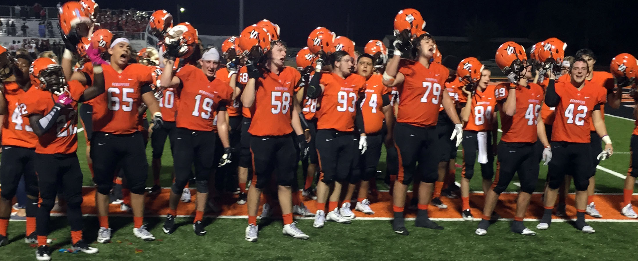 The Scrappers sing their fight song in front of the home stands after defeating Idabel 91-63 Friday night at Scrapper Stadium.