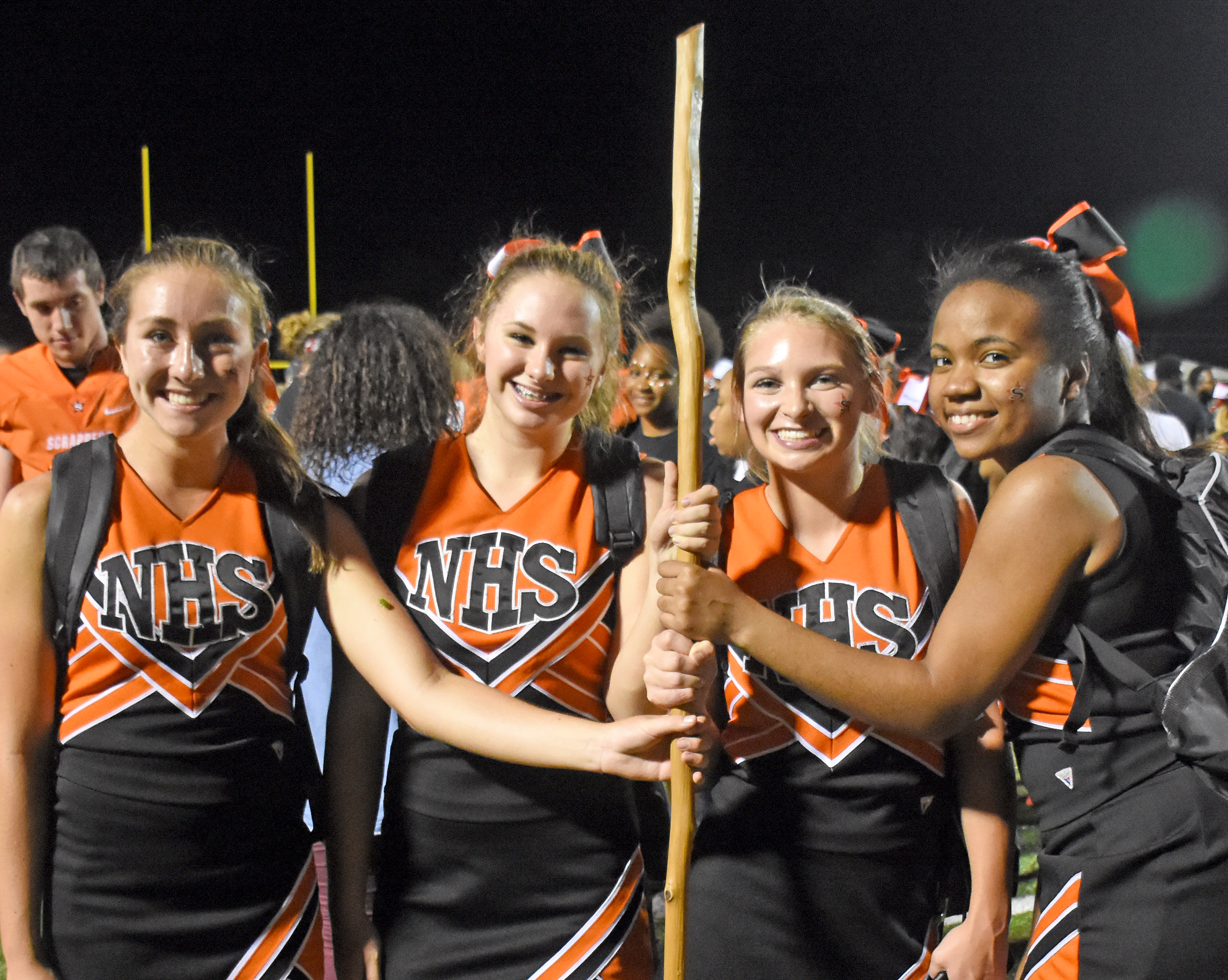Senior cheerleaders McKenzie Morphew, Nicole Dodson, Chelsey Hile, and Asia Harris make sure the stick is taken care of after the game.