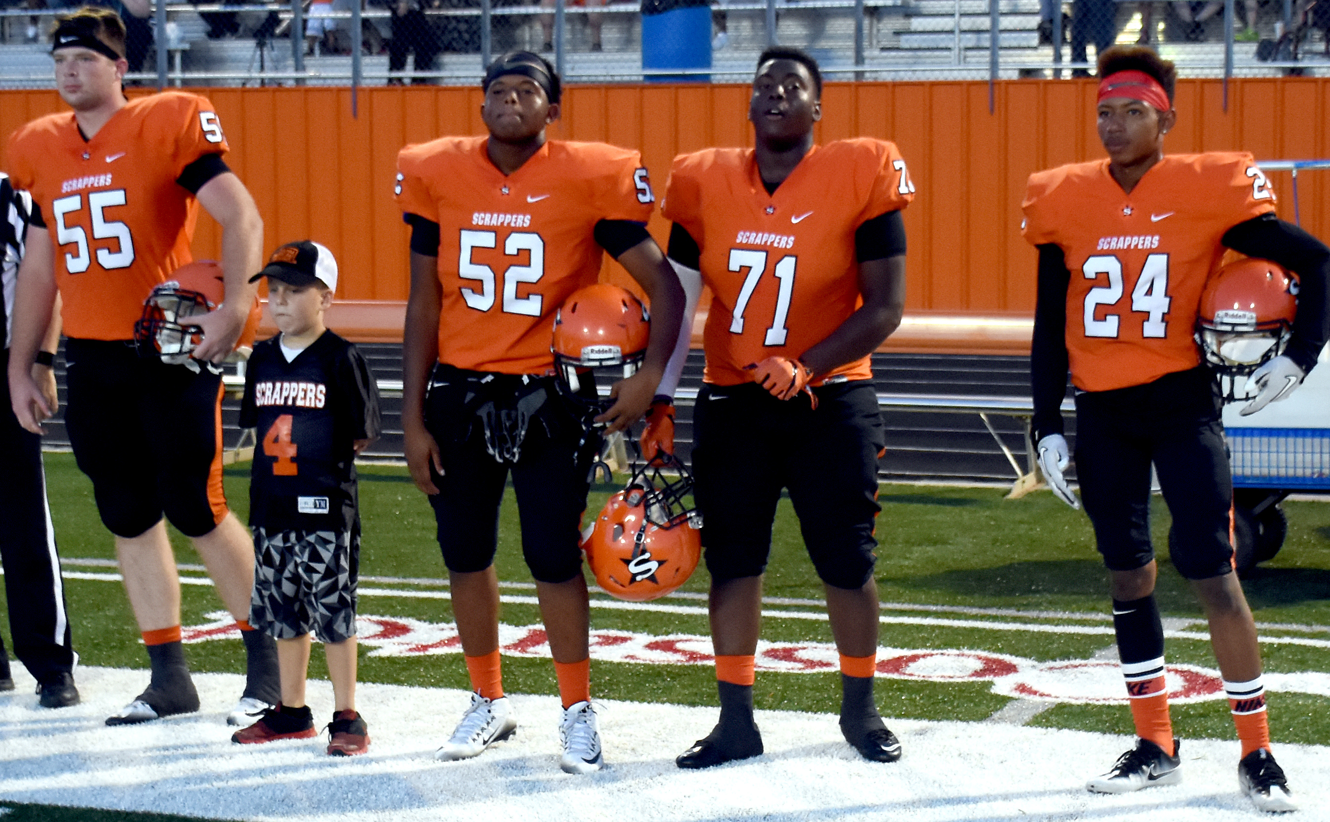 Team captains Austin Bowman, Halton Howard, Antonio Haney, Marquell McFalls, and Dennis Scott move toward midfield for the coin toss. Howard was Team Captain for a Day from last spring's Scrapper Showdown.