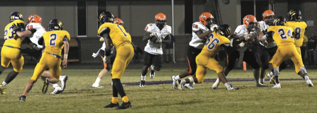 Scrapper offensive linemen clear the way for Darius Hopkins (12) on the fourth quarter drive which ended with Hopkins scoring the game-winning touchdown in Nashville's 56-51 come-from-behind victory.