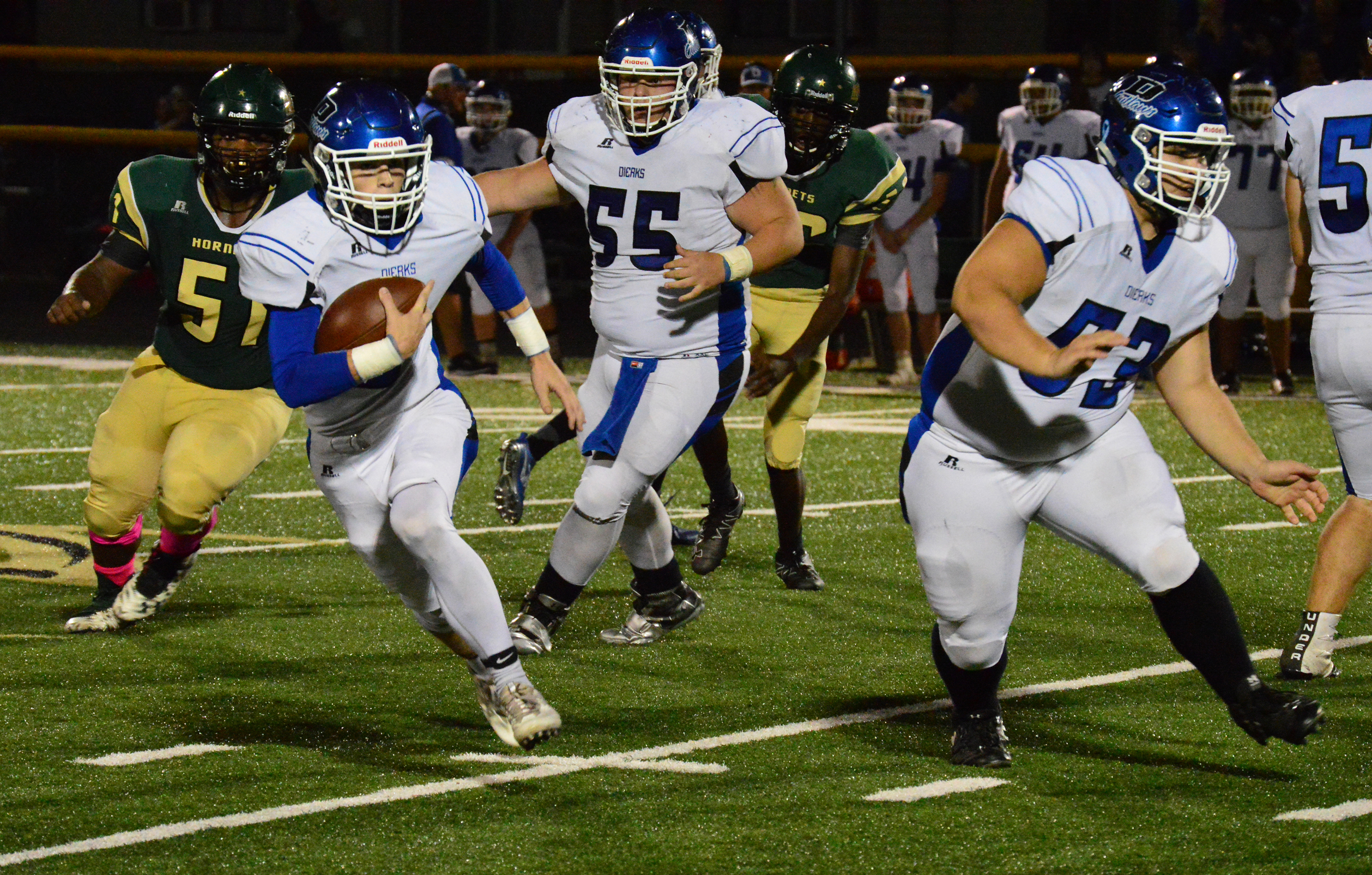 Dierks Outlaw senior Lane Woodruff carries the ball Friday night at Mineral Springs with an assist from Jeff Kompkoff (53). Woodruff accounted for 392 yards of the Outlaws' 650 total yards of offense.
