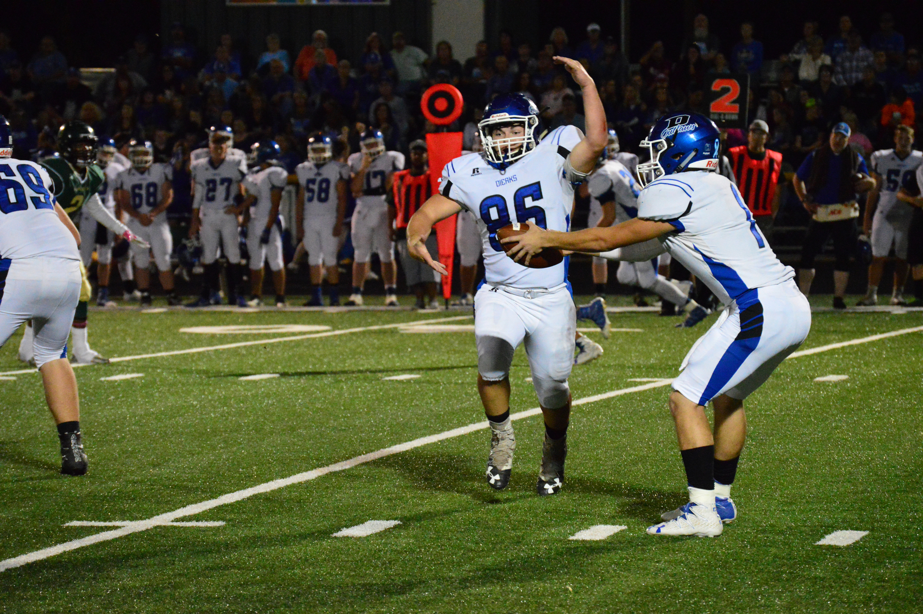 Dierks Outlaw running back Brayden Kirby (86) fakes a handoff with quarterback Caleb Adams during action Friday night.