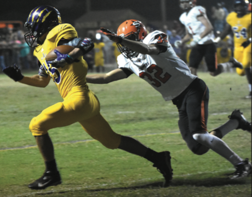 Kalob Carpenter (32) goes for the tackle on Ben Birtcher late in Friday night’s Scrapper victory over Ashdown.