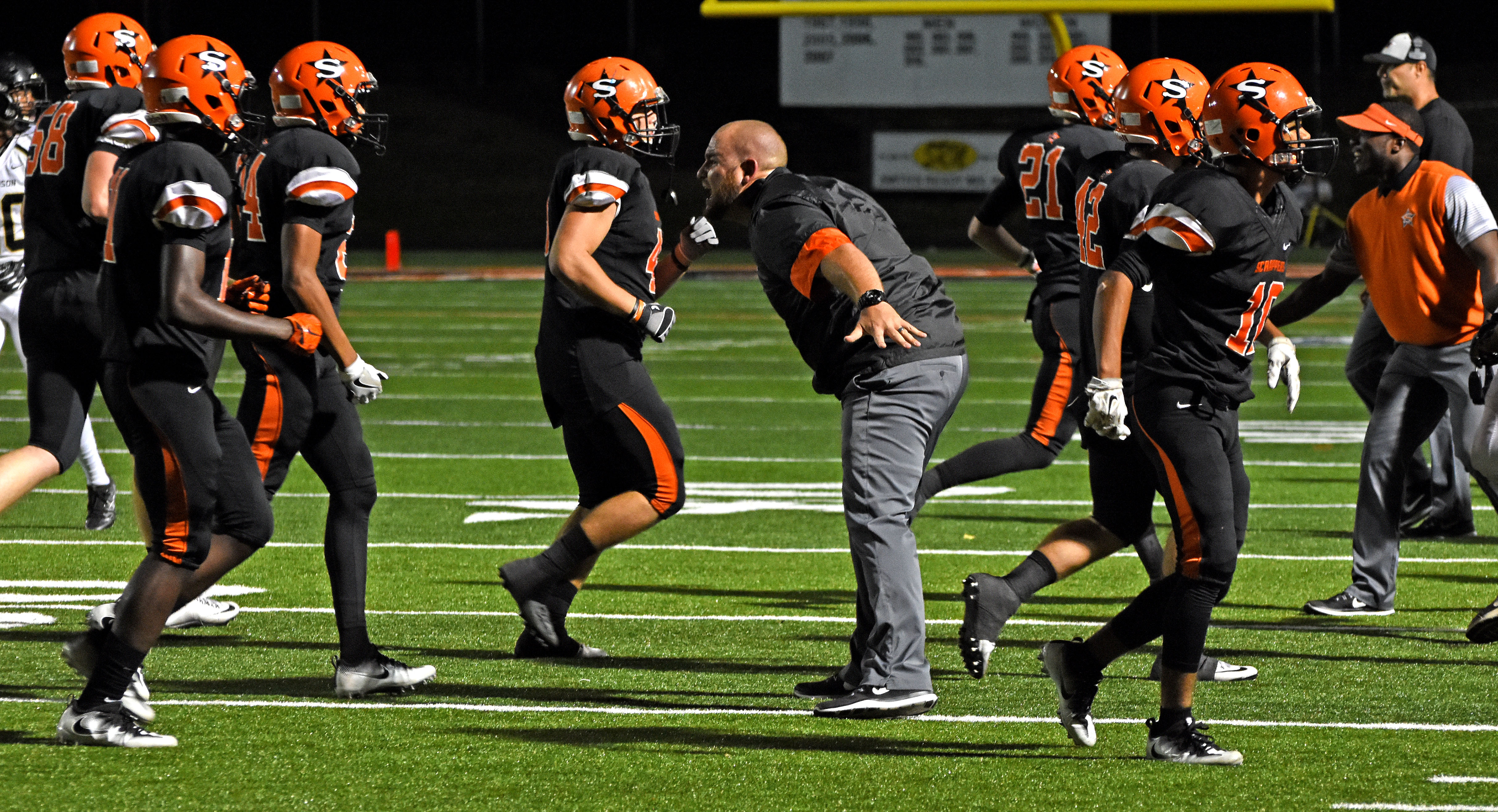Coach Brad Chesshir congratulates his Scrapper defenders after a Robinson turnover in Nashville's 31-28 District 7-4A victory last Friday night.