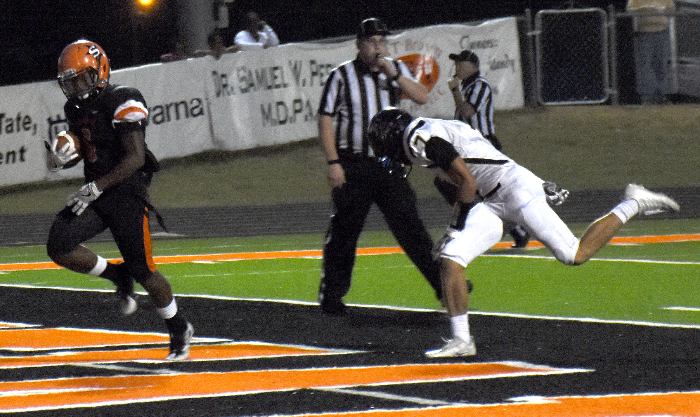 Trent Harris (6) outruns Corey Page of Joe T. Robinson for a Scrapper touchdown in the first quarter of Friday night's victory.