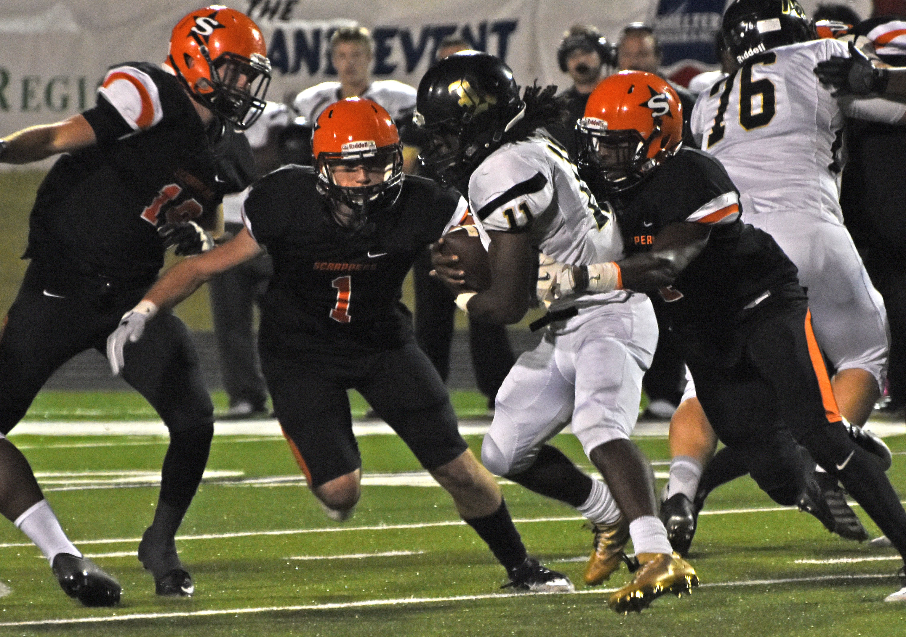 Hunter White (1) and Ty Pettway (4) move in for the tackle on Robinson Senator Myles Fells (11) Friday night at Scrapper Stadium.
