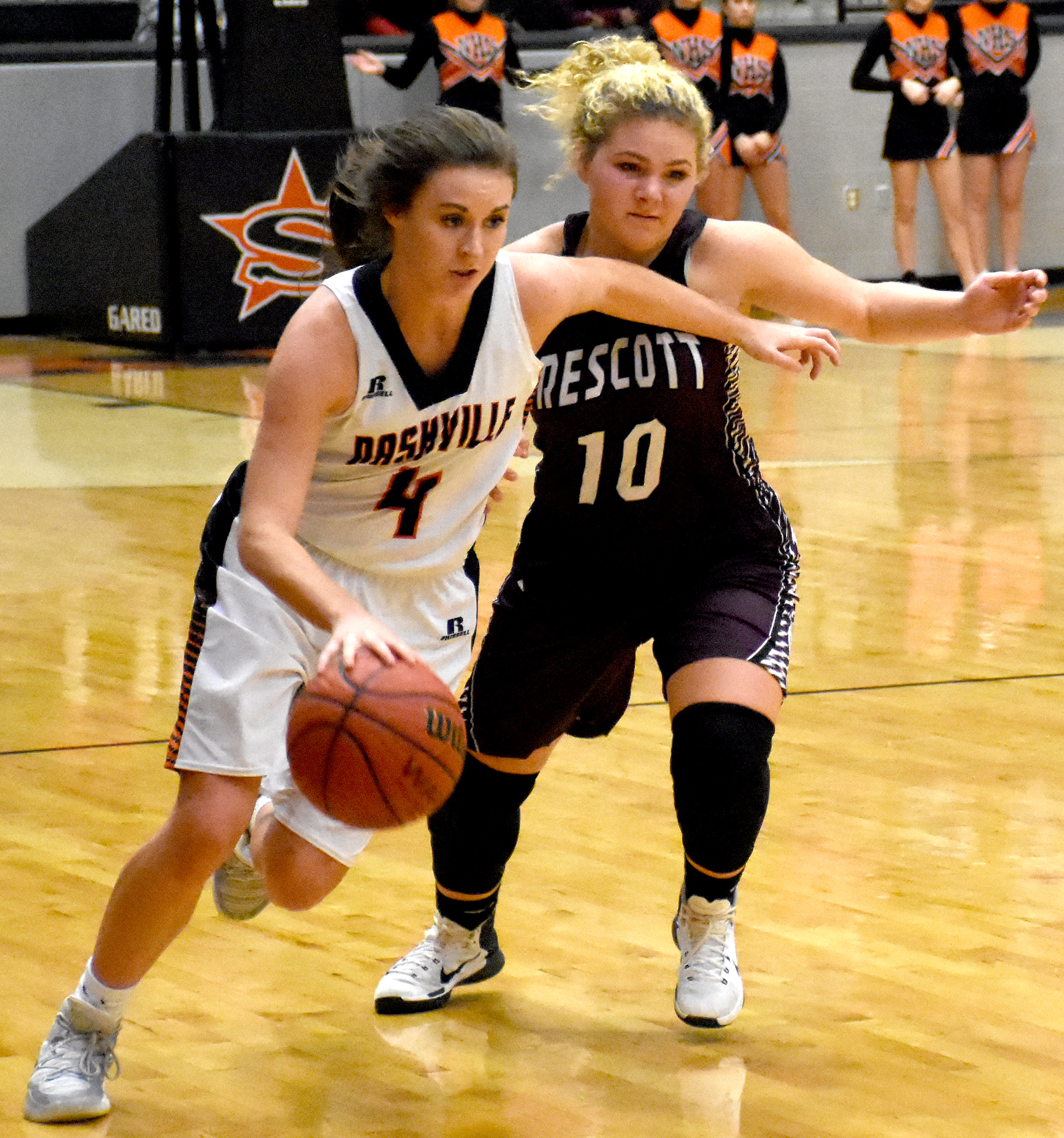 Kendall Kirchoff (4) drives the ball past the Lady Curley Wolf on her way to a basket for the Scrapperettes.